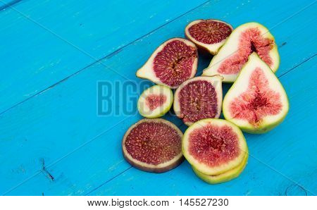 Fresh ripe figs on a blue wooden background