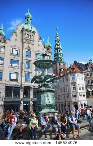 Copenhagen Denmark - August 15 2016: Many people near fountain Stork on Amagertorv square at the city centre. Copenhagen is the capital and most populated city of Denmark.