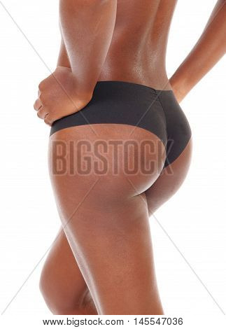 A closeup image of the back and butt of a young African American woman standing in black panties isolated for white background.