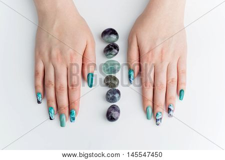 Closeup of woman nails with creative purple and green manicure. Fluorinit print. Copy space.