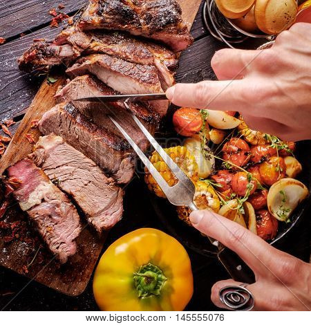 Grilled Steak Sliced On A Cutting Board.