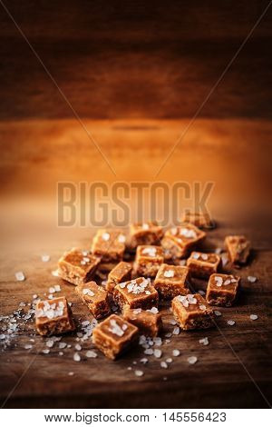 Caramel candies over dark background.Golden Butterscotch toffee caramel