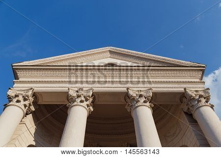 Capitol classical facade with columns on blue sky background. Bottom view