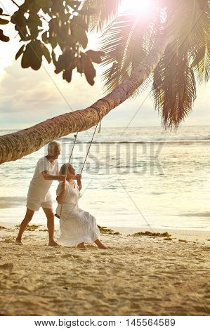 Happy elderly couple rest at tropical beac