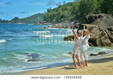 Happy elderly couple rest at tropical beac
