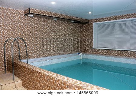 Sauna pool with blue water interior photo