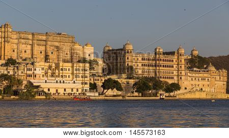 UDAIPUR INDIA - 20TH MARCH 2016: Part of the city palace in Udaipur during the day from the lake.