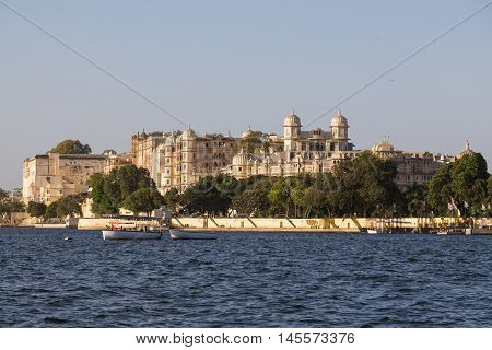 UDAIPUR INDIA - 20TH MARCH 2016: Part of the city palace in Udaipur during the day from the lake.
