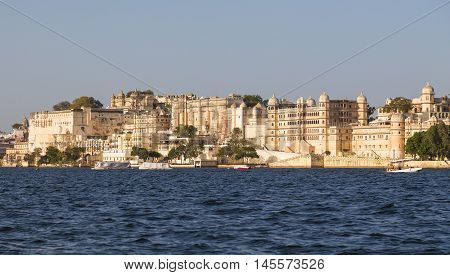 UDAIPUR INDIA - 20TH MARCH 2016: Part of the city palace in Udaipur during the day from the lake.