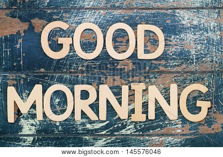 Good morning written with wooden letters on rustic surface