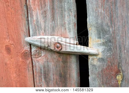 Old wooden latch in a barn doors.