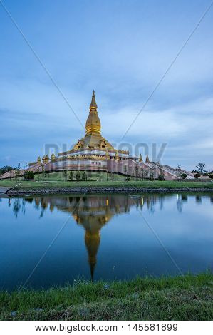 Famous Maha Mongkol Bua Pagoda In Roi-ed Thailand At Sunset.