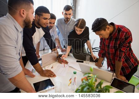 Picture of serious and executive office workers doing their job on board room in officeinterior. Business people working round table in office. Business plan and business project concepts.