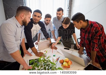 Business people working round table in office. Business plan and business project concepts. Picture of serious and executive office workers doing their job on board room in officeinterior.