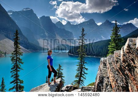 Woman at Moraine Lake in Rocky Mountains. Banff National Park Alberta Canada.