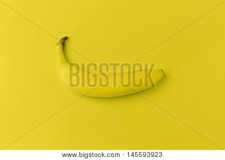 Banana on yellow background. Modern food background
