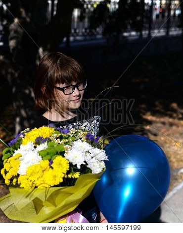 girl with a beautiful bouquet of flowers and a balloon