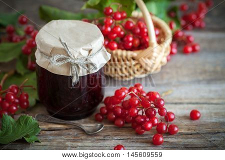 Jar Of Guelder Rose (red Viburnum) Jam And Basket With Red Healthy Berries On Background.