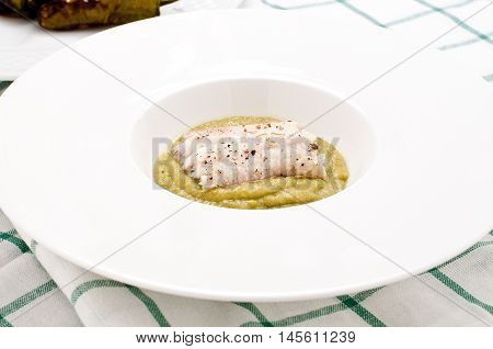 Fish cooked baked cod with friggitelli cooked in a pan with oil and garlic typical Italian vegetablesitaly