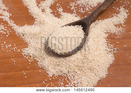 Farinha de Mandioca. Manioc. Cassava flour over a wooden table