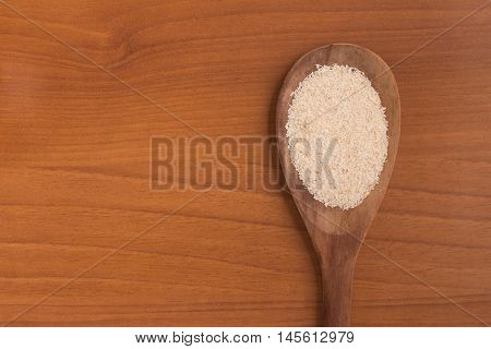 Farinha de Mandioca. Manioc. Cassava flour over a wooden table