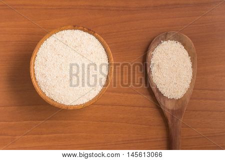 Farinha de Mandioca. Manioc. Cassava flour over a wooden table
