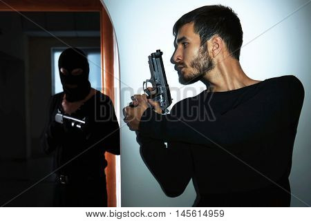 Armed thieves entering a house and man defending his property