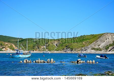 LULWORTH COVE, UNITED KINGDOM - JULY 19, 2016 - Boats moored in the bay Lulworth Cove Dorset England UK Western Europe, July 19, 2016.