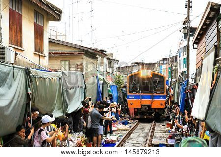 SAMUT SONGKHRAM THAILAND - SEPTEMBER 4 2016 : Mae Klong Market placed all product on railroad all vendors have to move product away when the train passes market.