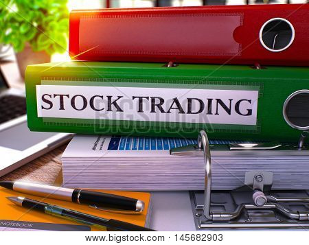 Green Ring Binder with Inscription Stock Trading on Background of Working Table with Office Supplies and Laptop. Stock Trading Business Concept on Blurred Background. 3D Render.