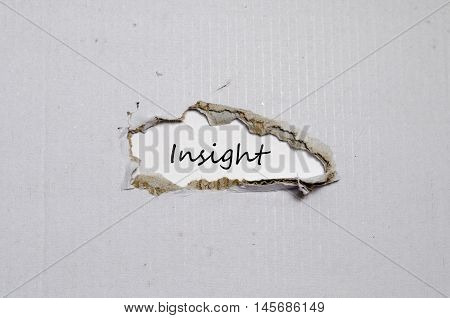 The word insight appearing behind torn paper