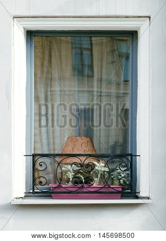 Window with a table lamp and decorative lattice with flowers
