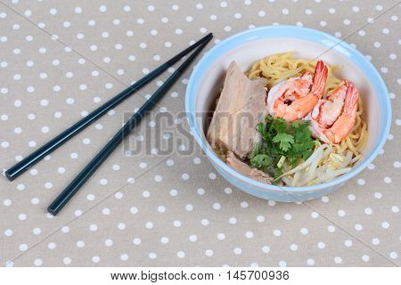 Japanese noodle "ramen" topped steamed streaky pork and shrimp in pork's bone soup and chopsticks on gray.