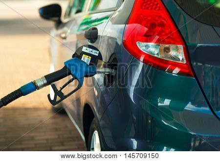 Car refueling on a petrol station closeup