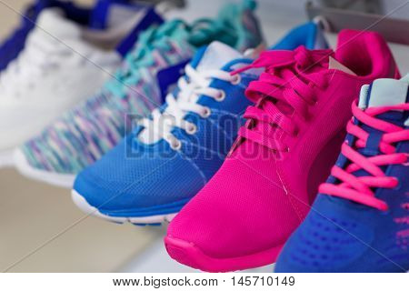 Variety of the colorful sneakers in the shop