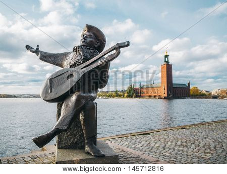 STOCKHOLM SWEDEN - OCTOBER 23 2014: Evert Taube Statue and City Hall in Stockholm.