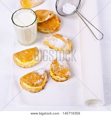 Homemade buns stuffed with cottage cheese on a wooden background. Selective focus.