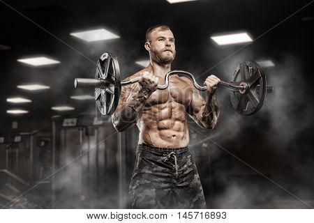 Strong Athletic Man bodybuilderl Torso showing muscles in gym