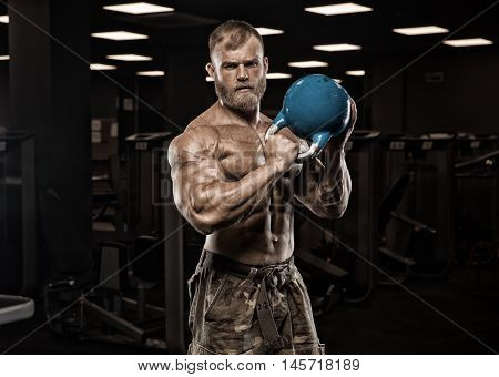 Strong Athletic Man bodybuilderl Torso showing muscles in gym