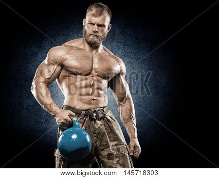 Strong Athletic Man bodybuilderl Torso showing muscles in gym