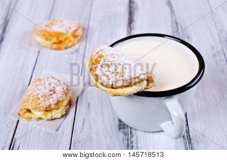 Homemade buns stuffed with cottage cheese on a wooden background. Selective focus.
