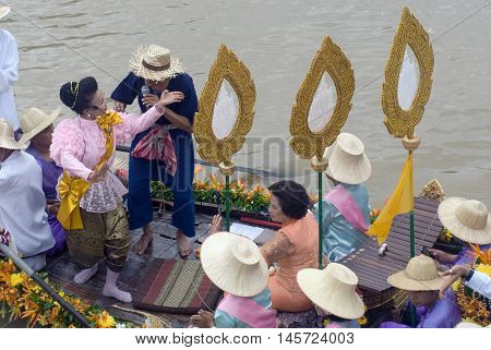 AYUTTHAYA, THAILAND - JULY 15, 2011: Unidentified people dancing show on the flower boats in candle floating parade, the unique annual candle festival of Buddhist lent  in Lad Chado, Ayutthaya, Thailand.