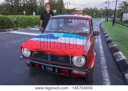 Kota Kinabalu,Sabah-Aug 31,2016:Portrait of man in antique car with Sabah flag during National day parade,celebrating the 59th anniversary of independence on 31st Aug 2016 at Kota Kinabalu,Sabah
