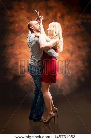 Young and sexy couple dances Caribbean Salsa
