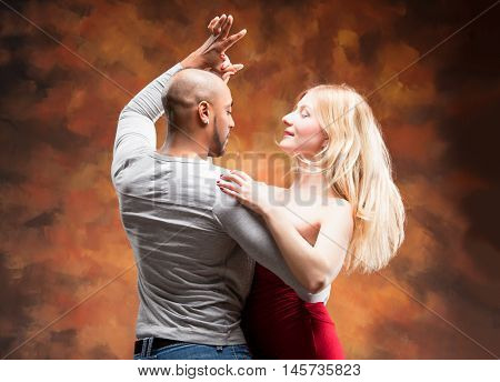 Young and sexy couple dances Caribbean Salsa