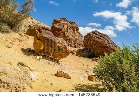 Boulders on the hill in Makhtesh Gadol or Large Crater, nature reserve in Negev desert, Israel