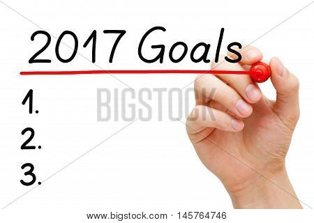 Blank list of goals for year 2017 isolated on white. Hand underlining 2017 Goals with red marker on transparent wipe board.