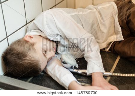 Fully Clothed Boy Unconscious On Shower Floor