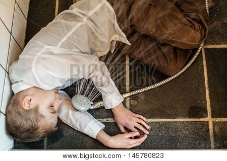 Overhead View Of Boy Passed Out In Bathroom