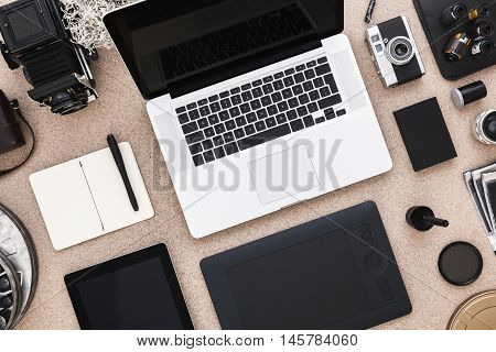 Photographer table with laptop, cameras, tablet Photographer workspace. . View from above. Flat lay